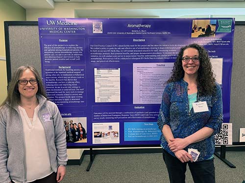 Nurses standing in front of a poster about aromatherapy