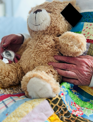 A teddy bear being held.