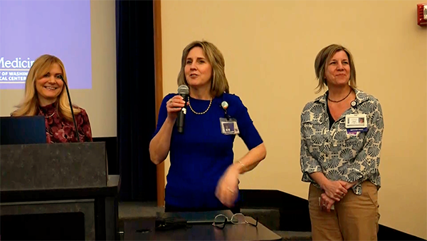 Christin Gordanier, Kellie Garth Green, and Cheri Constantino-Shor at a podium.