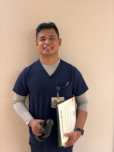 Deon Dumdumaya holding his DAISY award.