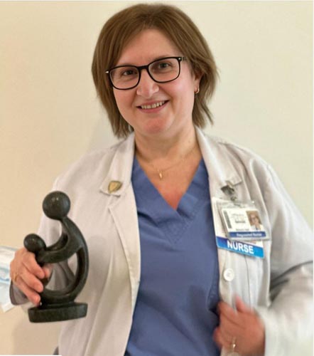 Ghada Bu Khuzam holding her DAISY award.