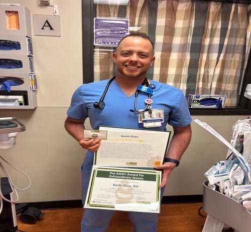 Keith Dias holding his DAISY award.