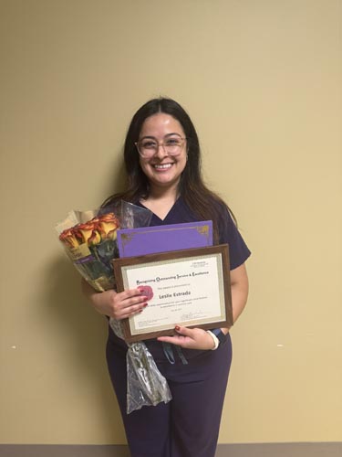 Leslie Estrada holding her ROSE award.