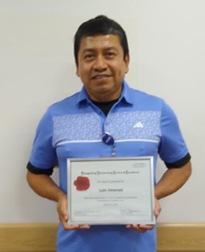Luis Jimenez holding his ROSE award.