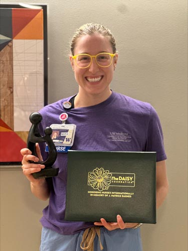Marie Schwartz holding her DAISY award.