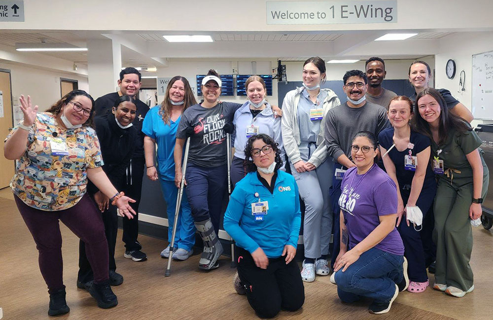 The nurses of the Northwest Oncology unit gathered at the nursing station posing.