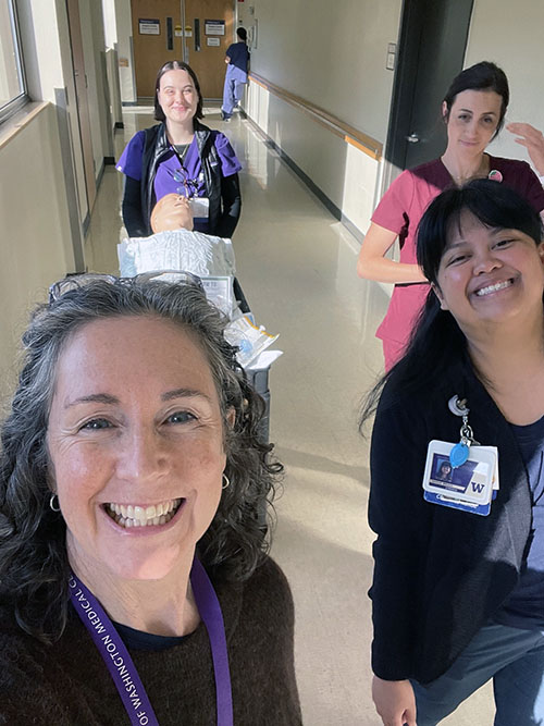 A selfie of the report authors smiling in a hospital corridor.