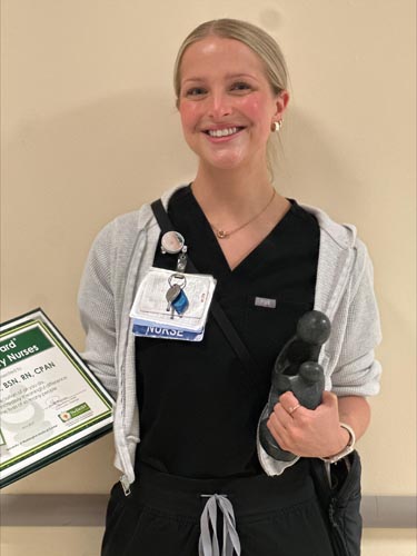 Rheese Dolgash holding her DAISY award.