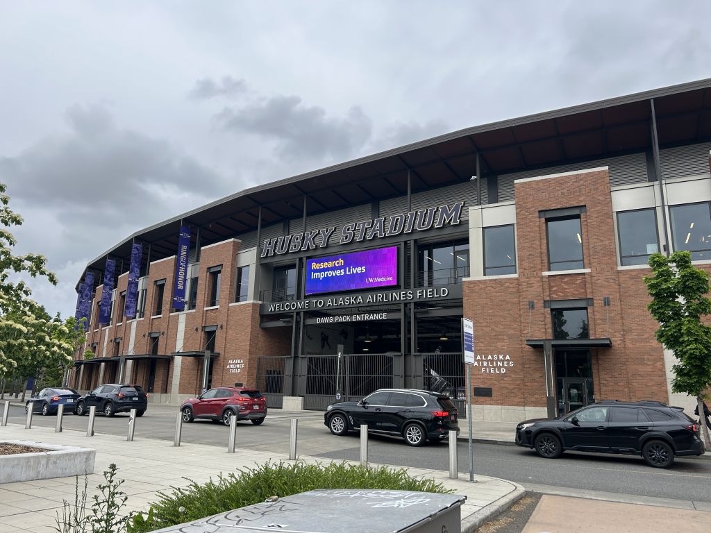 Image of Husky Stadium external billboard showing Research Improves Lives signage