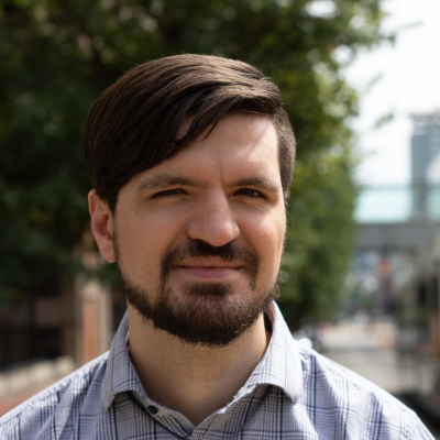 Man with dark hair and beard